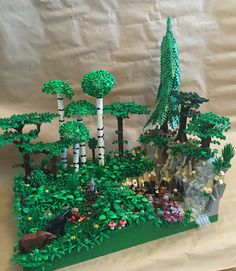 a lego model of a forest with trees and animals