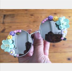 🌺Shade yourself from the sun in style with these pretty flower sunnies. 🌺These round sunnies have silver frames with silver mirrored lenses. On the sides of the glasses they have an array of pretty handmade flowers in shades of green, pink, purple and yellow with a few small flowers and pearls.  🌺Stand out  from the crowd in these sunglasses, perfect for holidays, Ibiza, festivals, carnivals etc. Dress them up for a special occasion or or down for everyday wear!  🌺 UV protection. 🌺All sunglasses are sent in a black pouch to keep them safe but please also handle with care as they are handmade. 🌺Check out the full collection of sunnies here:  https://etsy.me/2n7BAX8 ( Please note that colours may vary slightly depending on your screen / monitor) Silver Sunglasses With Mirrored Lenses For Spring, Silver Tinted Sunglasses For Spring, Silver Sunglasses With Uv Protection For Spring, Silver Sunglasses For Beach Spring, Silver Sunglasses For Beach And Spring, Silver Sunglasses For Beach And Spring Season, Silver Sunglasses For Beach Spring Season, Silver Sunglasses For Beach In Spring, Fun Spring Festival Sunglasses