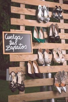 several pairs of shoes are on display in front of a sign that reads wegua tus zapatos