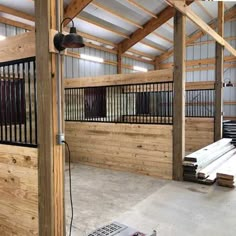 the inside of a building with wooden walls and metal balconies on either side