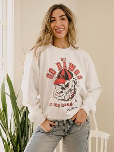 This is a PRE-ORDER item. Please allow 1-2 weeks for shipping. Our 50/50 Preshrunk Cotton/Polyester thrifted sweatshirts are meaningfully distressed and officially licensed. Each piece is one of a kind, and colors/distressing may vary from shirt to shirt.Pairs well with vintage denim and your favorite kicks.The details:- 50/50 Preshrunk Cotton/Poly Blend - Officially Licensed- Meaningfully Distressed, each piece unique- Colors + Distressing may vary Collegiate Sweatshirt With Screen Print, Relaxed Fit, Cotton Sweatshirt With Graphic Print For Game Day, Cotton Graphic Print Sweatshirt For Game Day, College Cotton Sweatshirt With Screen Print, Vintage Cotton Sweatshirt For Game Day, Collegiate Cotton Sweatshirt With Screen Print, Varsity Cotton Sweatshirt With Screen Print, Relaxed Fit Screen Print Sweatshirt For Game Day, Fan Merchandise Fall Sweatshirt With Screen Print