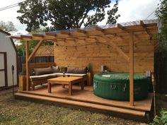 a backyard with a hot tub and patio furniture in the back yard, next to a shed