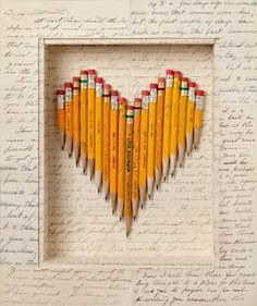 pencils are arranged in the shape of a heart