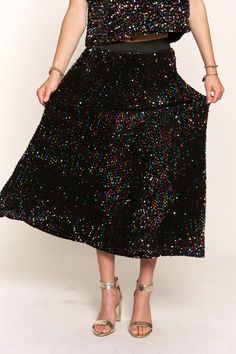 This Sequin Maxi Skirt is perfect for holidays and special occasions. The elastic waistband makes it comfortable and easy to wear, and the fully sequin design adds a touch of glamour. Whether it's a party or celebrating your favorite holiday, this maxi skirt adds the perfect finishing touch to any look. Fit: The skirt is intended to be fitted at the waist and relaxed throughout the hips and legs. Waist: The waist is intended to be fitted and ranges from 27" to 31" Hips: The hips are intended to Holiday Party Maxi Length Sequin Fabric, Holiday Party Sequin Fabric Maxi Length, Party Maxi Skirt With Lining, Disco Style Skirt For Evening Party Season, Disco Style Evening Skirt For Party Season, Disco Style Skirt For Evening And Party Season, Long Skirt For Prom And Party Season, Glamorous Maxi Skirt For Party Season, Spring Party Skirt With Elastic Waistband