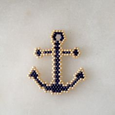 a beaded brooch with an anchor on it