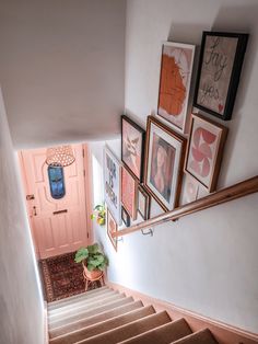 stairs with pictures on the wall above them