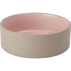 a white and pink bowl sitting on top of a table