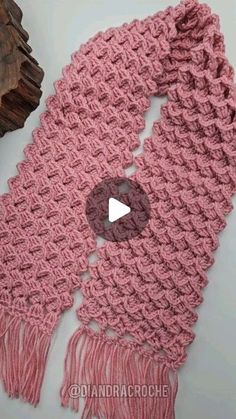 a crocheted scarf is shown with the video