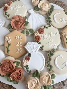 decorated cookies are arranged on a plate with the names and date printed on them,