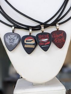 Rock Band Guitar Pick Necklace on a Genuine 3mm Black Leather Cord .  Guitar Band Picks  A. Linkin Park *sold* B. Led Zeppelin  *sold* C. Marilyn Manson *available* D. Hard Rock *sold* In notes please specify which pick you would like . Otherwise Random will be selected . Rockstar Girlfriend Accessories, Cord Guitar, Rock Accessories, Guitar Necklace, Emo Jewelry, Pick Necklace, Guitar Pick Necklace, Musician Gifts, Beads Bracelet Design