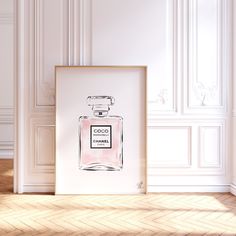 an art print with a chanel perfume bottle in front of a white wall and parquet floor