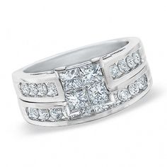 a white gold ring set with princess cut diamonds