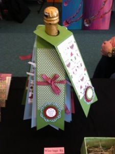 a table topped with lots of cards and wine bottle topper next to other items