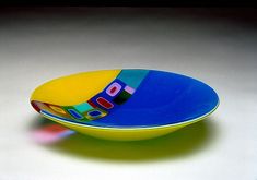 a colorful bowl sitting on top of a white table