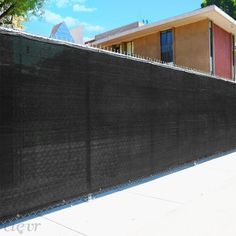 a black fence is in front of a building