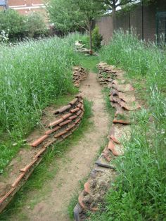 a path made out of bricks in the middle of a field