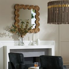 a living room filled with furniture and a mirror on top of a fireplace mantel