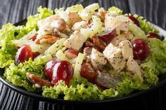 chicken salad with cherries and pecans on a black plate