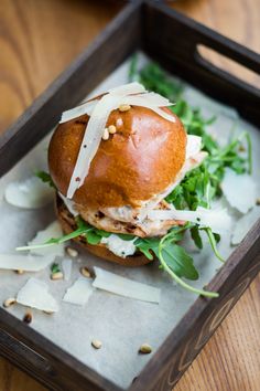 a close up of a sandwich in a tray on a table