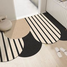 three round rugs on the floor in front of a radiator and door