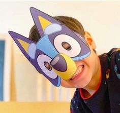 a young boy wearing a cartoon mask on his face