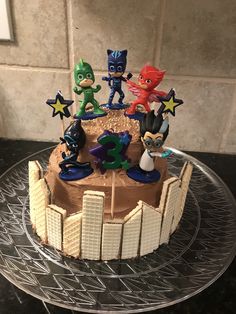 a cake decorated with cartoon characters on top of it