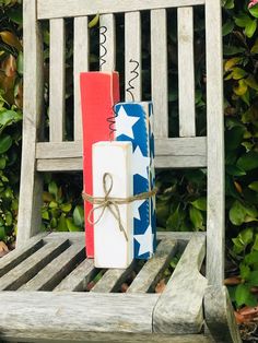 two wrapped presents sitting on top of a wooden chair in front of some bushes and shrubbery