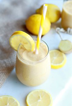 a smoothie with lemons and a straw in it