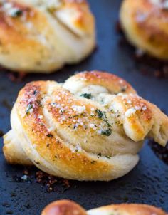 garlic knots on a baking sheet with text overlay