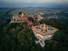 an aerial view of a building in the middle of trees