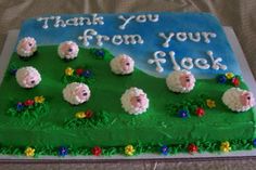 a sheet cake decorated with sheep and flowers