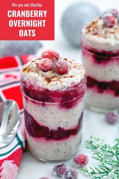 two jars filled with cranberry overnight oats on top of a white table