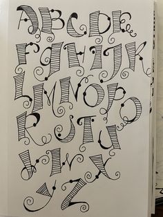 the letters are drawn in black and white ink with swirly lines on them, as well as some type of lettering