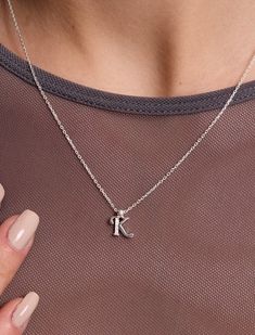 Introducing our Sterling Silver Letter Necklace, a delicate expression of personal style. This Tiny Initial Necklace features the letter "K" elegantly crafted to adorn your neckline with subtle charm. Plated in lustrous gold, this Dainty Initial Necklace adds a touch of sophistication to any outfit. Embrace individuality with this Small Monogram Necklace, a timeless accessory that speaks volumes in its simplicity. 🤍Each piece is meticulously crafted, offering a unique and intimate touch. Ideal Silver Letter Necklace, Silver Letter Initial Necklace, Silver Initial Letter Charm Necklace, Silver Tarnish-resistant Pendant Initial Necklace, K Necklace Letter Silver, Letter K Necklace, K Necklace, Elegant Letter-shaped Initial Necklace, Letter Necklace Silver