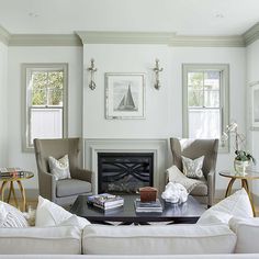 a living room filled with furniture and a fire place in the middle of a room