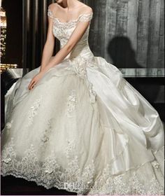 a woman in a wedding dress is posing for the camera with her hand on her knee