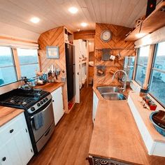 the interior of a mobile home with wood flooring and white cabinets is shown in this photo