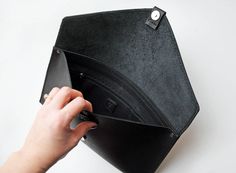 This black leather envelope clutch has simple and delicate design. It's beautifully compliment any of your outfits-be it casual or bizarre. The clutch is made of black, matt genuine leather, closes with magnet, hided under leather loop. There is also one zipper pocket inside. It is 100% handmade and designed in our beautiful workshop ErikasLeather. Main color: Black Material: Black leather Magnet closure Measurement: Width 35 cm (~ 14 inch) Height 20 cm (~ 8 inch) Please feel free to contact us Black Office Clutch With Magnetic Closure, Black Clutch With Magnetic Closure, Black Envelope Clutch For Daily Use, Black Clutch With Interior Card Slots As Gift, Minimalist Envelope Clutch For Everyday Use, Black Leather Clutch With Interior Card Slots, Black Minimalist Clutch For Daily Use, Minimalist Black Leather Clutch, Black Leather Minimalist Clutch