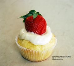 a cupcake with cream and a strawberry on top