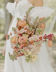 a woman holding a bouquet of flowers in her hands