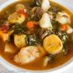 a white bowl filled with meat and vegetable soup