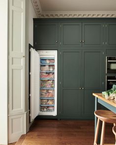 an open refrigerator in a kitchen next to a counter