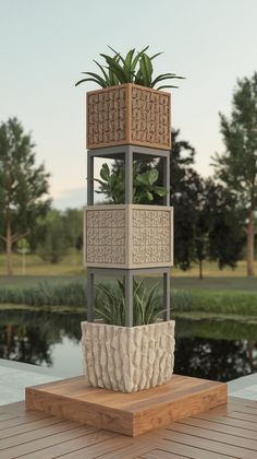 a potted plant sitting on top of a wooden table next to a lake with trees in the background