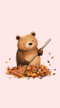 a brown bear holding a broom and surrounded by leaves