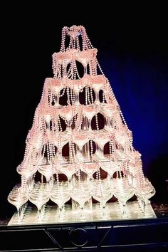 a large christmas tree made out of wine glasses