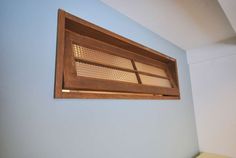 a window in the corner of a room with blue walls and wooden trim on it