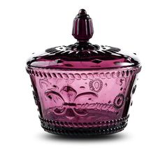 a pink glass jar with an ornate design