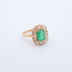 Indulge in luxury with our exquisite Emerald and Diamond Cocktail Ring. Adorned with stunning emeralds and diamonds, this ring exudes sophistication and elegance. Elevate any outfit with this timeless piece, perfect for any occasion. Feel like a true icon when you wear our Emerald & Diamond Cocktail Ring. 14k Yellow Gold 1.75CTW Natural Emerald Natural Diamonds: .80CTW Round Diamonds Luxury Cluster Emerald Ring With Diamonds, Formal Emerald Diamond Ring With Center Stone, Luxury Green Emerald Ring With Rose Cut Diamonds, Luxury Green Cluster Ring For Formal Occasions, Luxury Green Cluster Ring For Formal Events, Formal Cluster Emerald Ring With Center Stone, Luxury Cluster Emerald Ring, Green Cluster Luxury Ring, Luxury Emerald Cluster Ring With Halo Setting