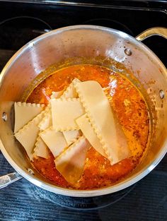 some ravioli and sauce in a pot on the stove