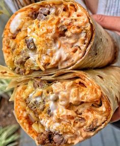 two burritos with meat and cheese on them